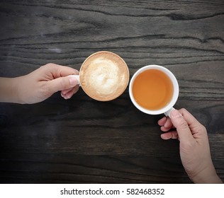 Top View Image Of Two Hands Holding A Cup Of Coffee With A Cup Of Hot Tea - Vintage Style