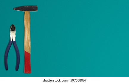 A Top View Image Of Various Hand Tools On A Clean Work Bench, Plier With Hammer