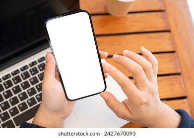 Top view image of a woman using her smartphone while working remotely at a cafe. A white-screen smartphone mockup to display your graphic ads.