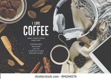 top view image of workspace. tablet computer, coffee and scarf on black table. over light and vintage tone
