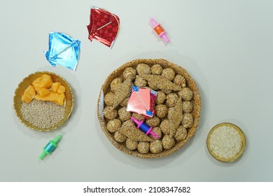 Top View Of Indian Sweet Til Ladoo With Miniature Kites And Reel 