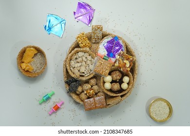 Top View Of Indian Sweet Til Ladoo With Miniature Kites And Reel 