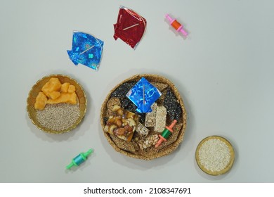 Top View Of Indian Sweet Til Ladoo With Miniature Kites And Reel 