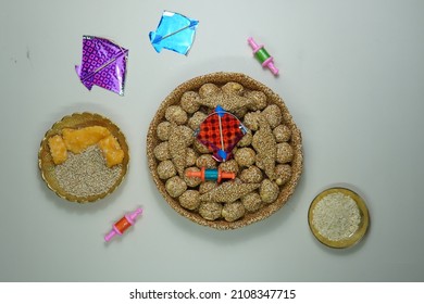 Top View Of Indian Sweet Til Ladoo With Miniature Kites And Reel 