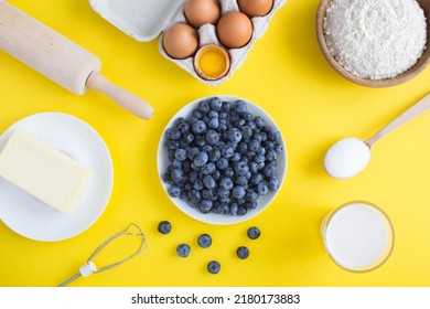 Top View Of Ingredients For Making Blueberry Pie Or Cake On The Yellow Background. Closeup.