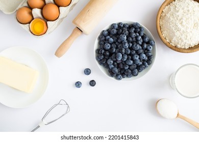 Top View Of Ingredients For Making Blueberry Pie Or Cake On The White Background. Copy Space.