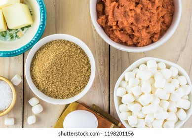 Top View Of Ingredients For Sweet Potato Casserole - Bowl With Brown Sugar, Marshmallows, Sweet Potatoes, Butter.