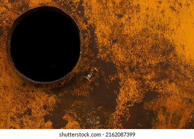 top view of iron container. cement silo. worn out rusty metal texture background. Rust texture on metal. abstract background. old metal iron rust. orange colored rusty metal. black hole