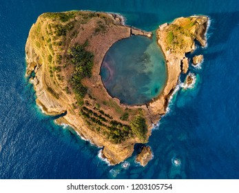 Top view of Islet of Vila Franca do Campo is formed by the crater of an old underwater volcano near San Miguel island, Azores, Portugal. Bird eye view, erial panoramic view.