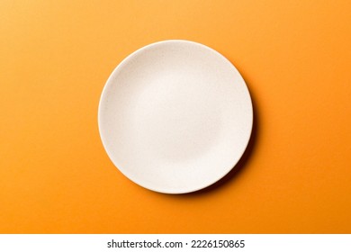 Top view of isolated of colored background empty round beige plate for food. Empty dish with space for your design. - Powered by Shutterstock