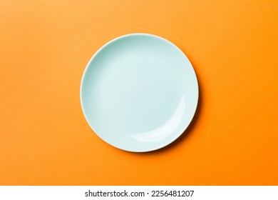 Top view of isolated of colored background empty round blue plate for food. Empty dish with space for your design. - Shutterstock ID 2256481207