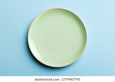 Top view of isolated of colored background empty round green plate for food. Empty dish with space for your design.