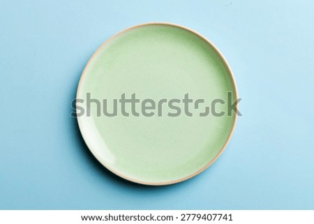 Top view of isolated of colored background empty round green plate for food. Empty dish with space for your design.
