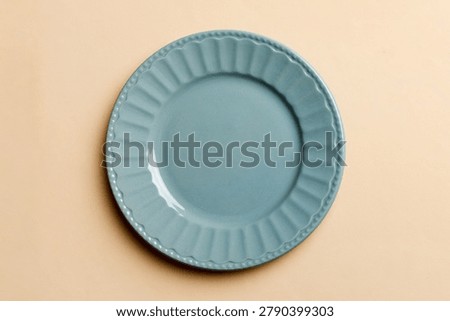 Top view of isolated of colored background empty round blue plate for food. Empty dish with space for your design.