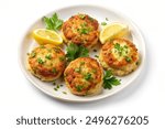 Top view, isolated on white background, of a plate of crab cakes.