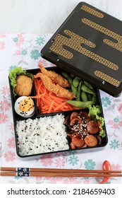 Top View Japanese Bento Lunchbox With Steamed Vegetable, Boiled Egg, Nugget, Sausage, Edamame, And Tempura