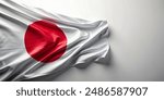 Top view of a Japanese flag on a white surface, featuring ample empty space for text.