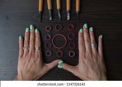 Top view jeweller's tools - pliers, cutters, carving knives, moulds, raw silver  pieces, engraver, sander, jeweler's bench pin - Powered by Shutterstock