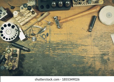 Top View Jewelry Maker Workbench With Tools On Table. Equipment And Tools Of A Goldsmith On Wooden Working Desk Inside A Workshop.