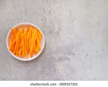 Top view of juicy sliced ​​carrots. Julienne carrot in a white plate. Copy space. - Powered by Shutterstock