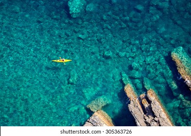 Top view of kayak boat oin shallow turquoise water of Ligurian sea, Italy