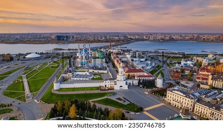 A top view of the Kazan Kremlin with the Qul Sharif Mosque, Preobrazhensky Cathedral and Suyumbike Tower. Spasskaya Tower - the main entrance to the Kremlin. Cityscape with the Kazanka River.