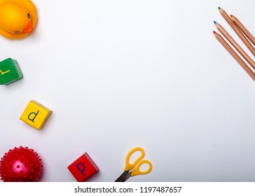 Top view of kids background with toys on white. Wooden cubes, colorful toy bricks, pencils, magnifying glass on white background. Educational toys for preschool, kindergarten or daycare. Kid's dream - Powered by Shutterstock