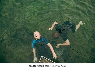 Top View Of Kids Swimming In Clear Blue Water At The Bogey Hole In Newcastle, New South Wales Australia