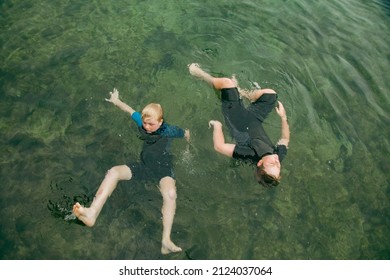 Top View Of Kids Swimming In Clear Blue Water At The Bogey Hole In Newcastle, New South Wales Australia