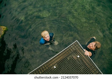 Top View Of Kids Swimming In Clear Blue Water At The Bogey Hole In Newcastle, New South Wales Australia