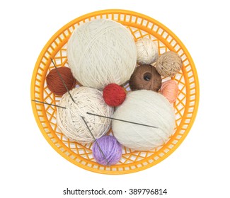 top view of the knitting, tools and accessory in a plastic basket isolated on a white background