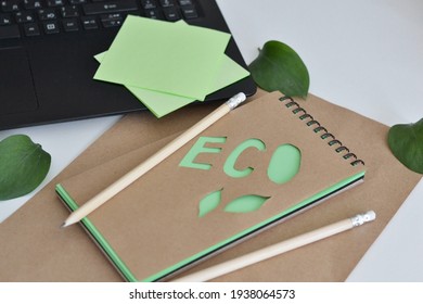 Top View Of  Kraft Notebook With Green Leaf, Keyboard. Office Eco Friendly, Home Office Desktop Organisation, Work From Home. 