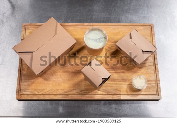 top view of kraft paper food containers with\
meal for delivery
