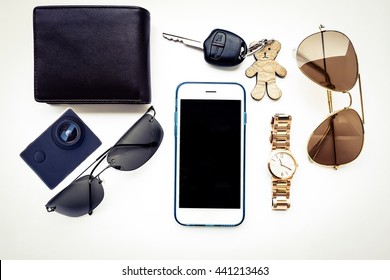 Top View Of Lady Set: Watches,camera, Car Keys, Sunglasses,and Smartphone On White Background 