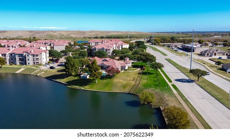 Top view lakeside new development apartment complex near highway with DFW landfill community waste disposal background. Waterfront multistory rental property business commercial buildings