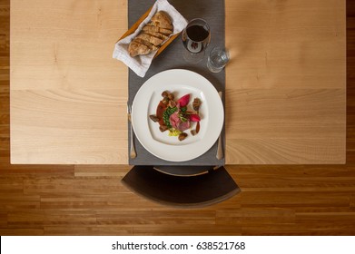 top view of a lamb dish with vegetables served on a plate