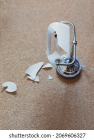 Top View Of A Lamp With Broken Glass Lamp Shade On The Floor Of An Office