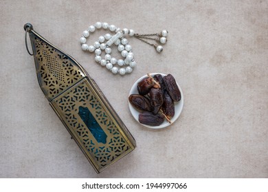 Top View Of Lantern, Dates Fruit And Rosary Beads. Ramadan And Eid Photo Concept.