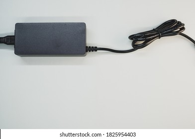 A Top View Of A Laptop Charger Isolated On A Gray Background