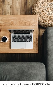 Top View Of Laptop, Coffee Cup And Candle On Wooden Table. Blogger / Freelancer Home Office Workspace Flatlay. Modern Nordic Interior Design Concept.