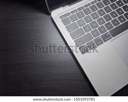 Top view of laptop computer keyboard on black background.