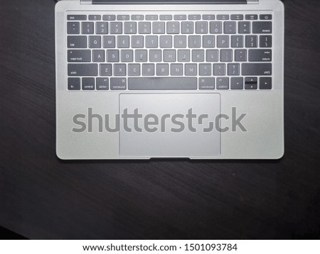 Top view of laptop computer keyboard on black background.