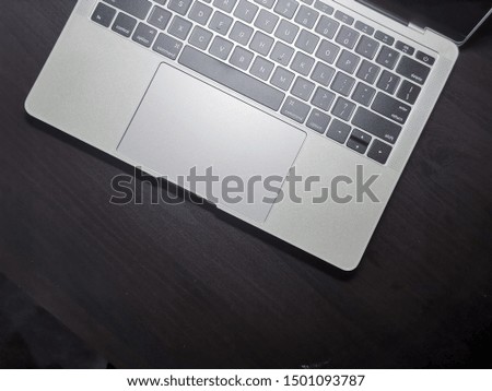 Top view of laptop computer keyboard on black background.