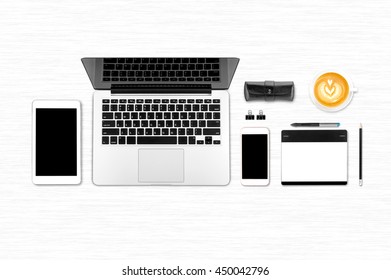 Top view laptop computer with mobile phone, cop of coffee, tablet, pencil and graphic tablet on office desk table.Business template mock up for adding your text.