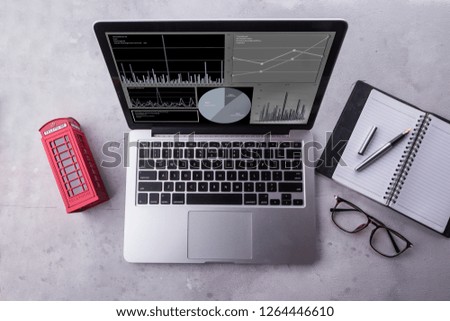 Top view of a laptop computer with statistics data on a screen. Working with financial graphs charts, using business software for data analysis and project management concept.