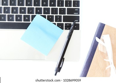 Top View Of Laptop Computer And Sticker Note On White Office Desk Table.Flat Lay