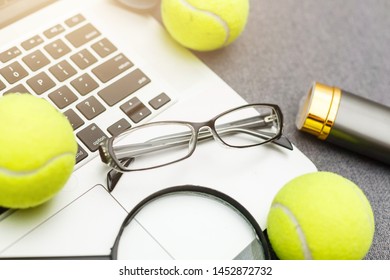 Top View Of Laptop, Sports Equipment, Tennis Ball, Shuttlecock, Glasses Aon The Sports Administration Gray Table.Business Concept.