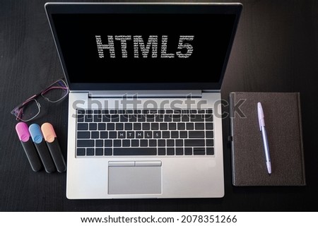 Top view of laptop with text HTML5. Html5 inscription on laptop screen and keyboard. Learn html language, computer courses, training. 