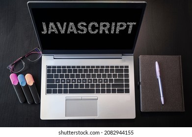 Top view of laptop with text Javascript. JavaScript inscription on laptop screen and keyboard. Learn programming language, computer courses, training. 