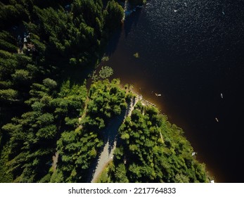 Top view of a large dark river, coniferous forest on a high bank, walking paths. Beautiful landscape. calm scenes. There are no people in the photo. Map, topography, geology, ecology. - Shutterstock ID 2217764833